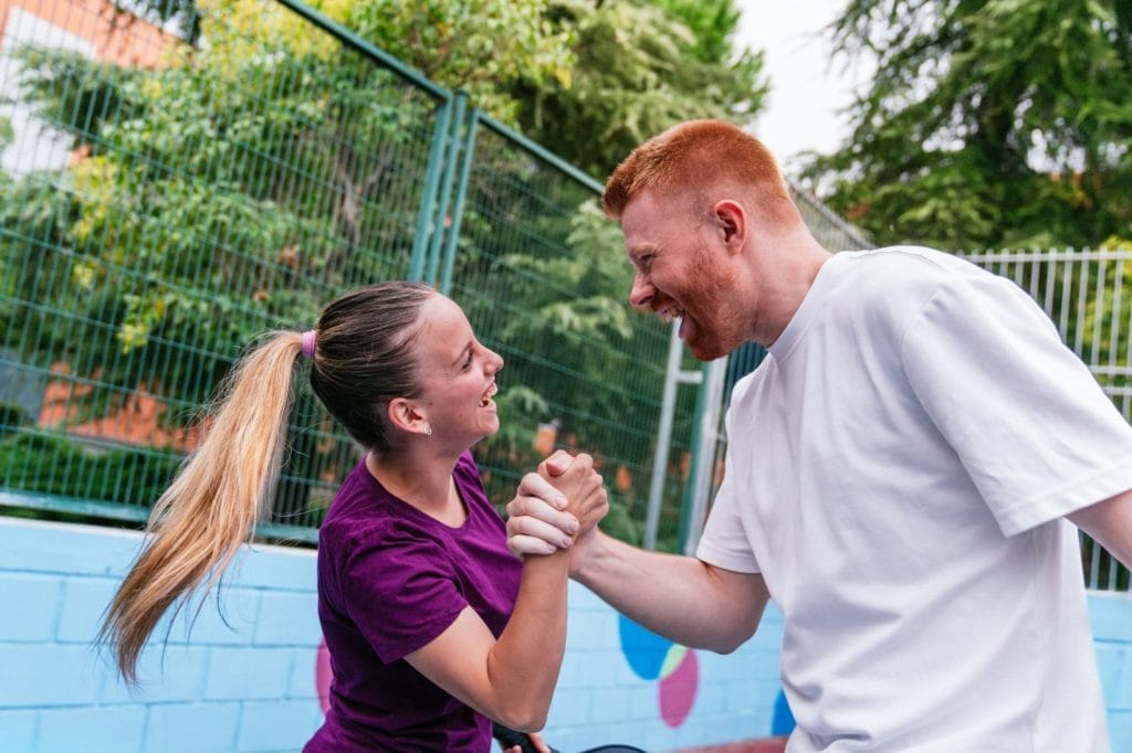 Pickleball players shaking hands after a match point